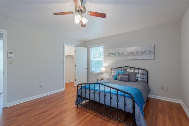 2650 Montego Dr, Buford, GA 30519 - bedroom featuring wood finished floors, baseboards, a spacious closet, ceiling fan, and a closet