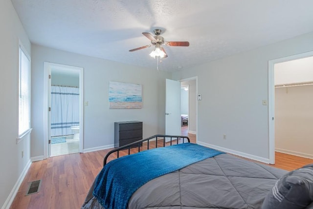 2650 Montego Dr, Buford, GA 30519 - bedroom featuring wood finished floors, a walk in closet, and baseboards
