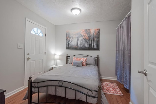 2650 Montego Dr, Buford, GA 30519 - bedroom with wood finished floors, a textured ceiling, and baseboards