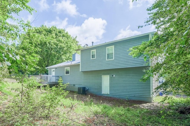 2650 Montego Dr, Buford, GA 30519 - rear view of house with a deck, central AC, and a chimney