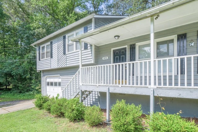 2650 Montego Dr, Buford, GA 30519 - view of front of home with covered porch, an attached garage, and stairs