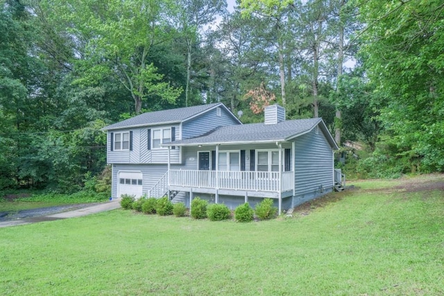 2650 Montego Dr, Buford, GA 30519 - split level home with a porch, a chimney, asphalt driveway, and a front yard