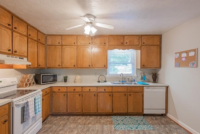 2650 Montego Dr, Buford, GA 30519 - kitchen with white appliances, under cabinet range hood, a sink, light countertops, and brown cabinetry
