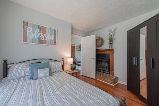 2650 Montego Dr, Buford, GA 30519 - bedroom featuring wood finished floors and a fireplace