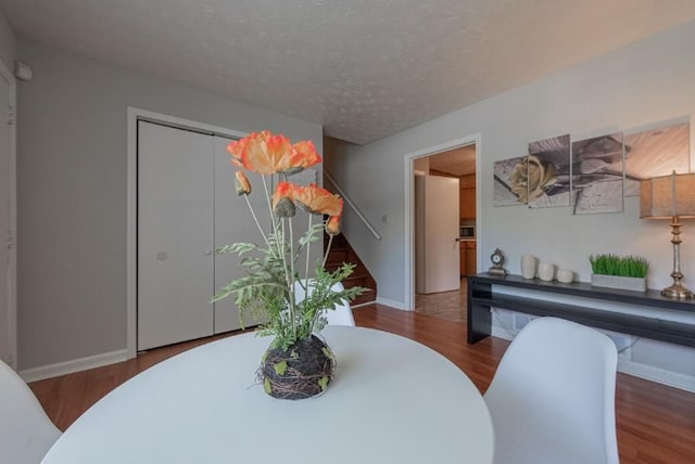 2650 Montego Dr, Buford, GA 30519 - dining area featuring wood finished floors, baseboards, and a textured ceiling
