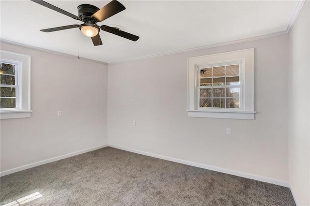 empty room featuring baseboards, ornamental molding, carpet, and a healthy amount of sunlight