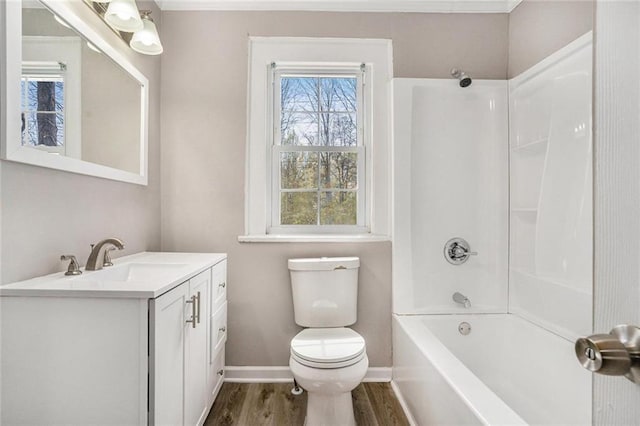 full bathroom featuring vanity, wood finished floors, toilet, and a healthy amount of sunlight