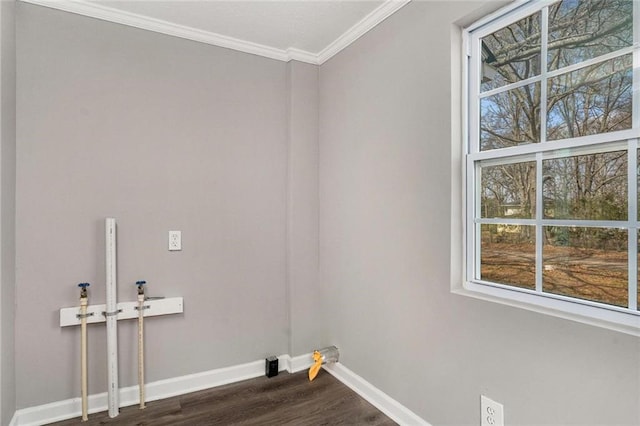 laundry area with dark wood-style floors, laundry area, ornamental molding, and baseboards