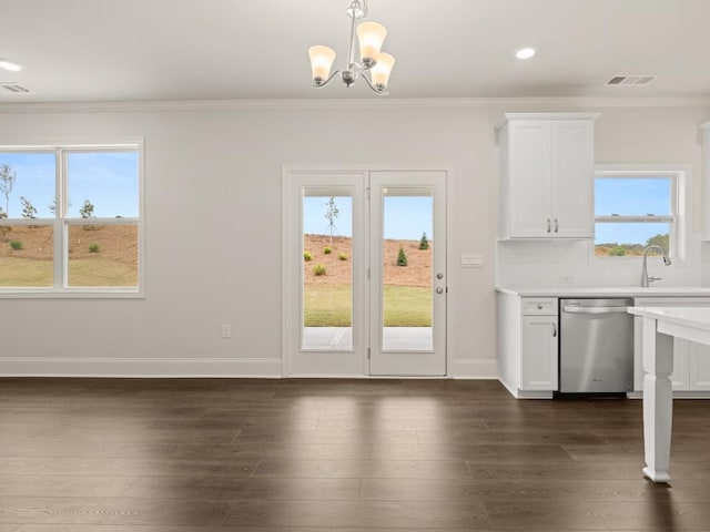 kitchen featuring crown molding, light countertops, a sink, dishwasher, and visible vents