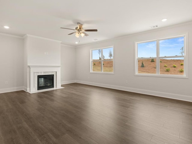 unfurnished living room with crown molding, baseboards, a ceiling fan, and dark wood-style flooring