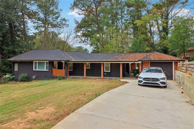 ranch-style home with a garage and a front lawn