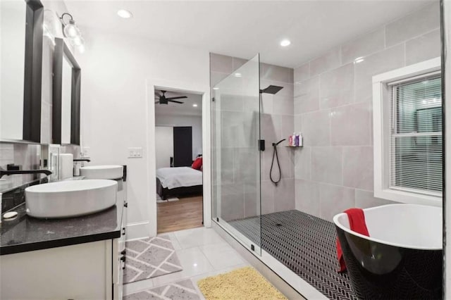 bathroom featuring tile patterned floors, vanity, separate shower and tub, and ceiling fan