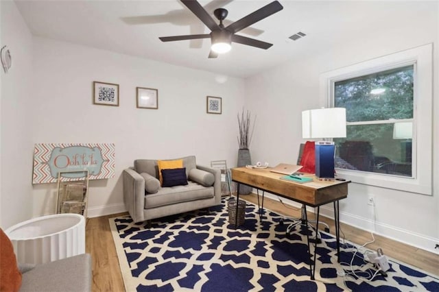 home office with ceiling fan and hardwood / wood-style flooring