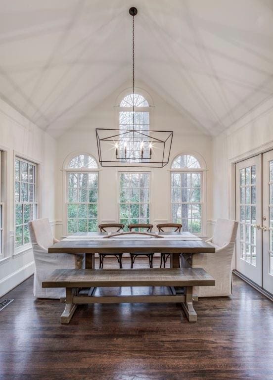 dining space featuring lofted ceiling, dark hardwood / wood-style floors, and french doors