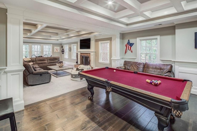 recreation room with coffered ceiling, crown molding, a wealth of natural light, and dark hardwood / wood-style floors