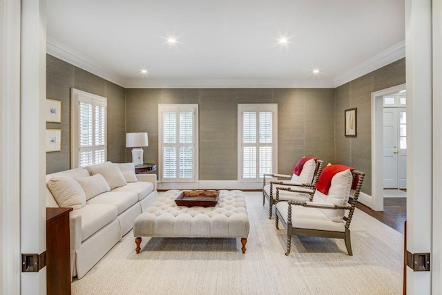 living room featuring crown molding, a wealth of natural light, and light wood-type flooring