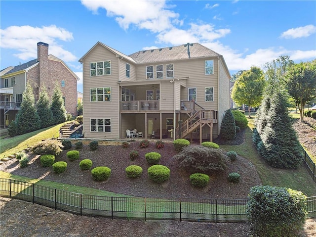 rear view of house featuring a patio, stairs, and fence