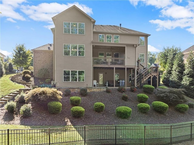 back of house featuring stairs, a deck, fence, and ceiling fan