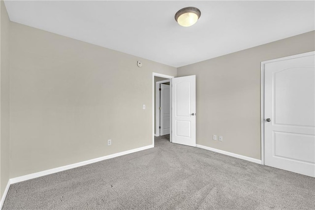 unfurnished bedroom with carpet floors and baseboards