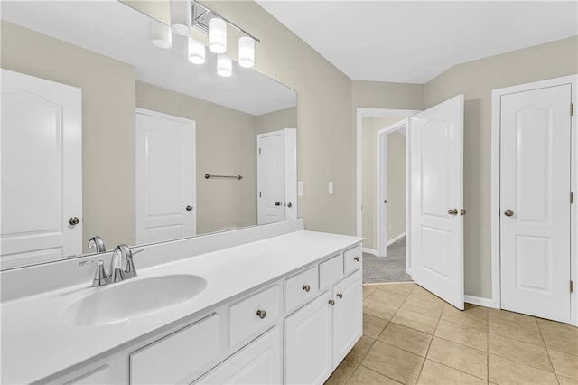 bathroom featuring vanity, tile patterned flooring, and baseboards