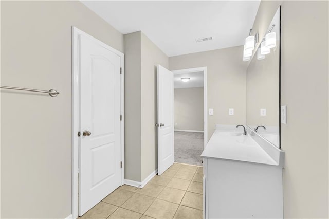 bathroom with tile patterned floors, baseboards, vanity, and visible vents