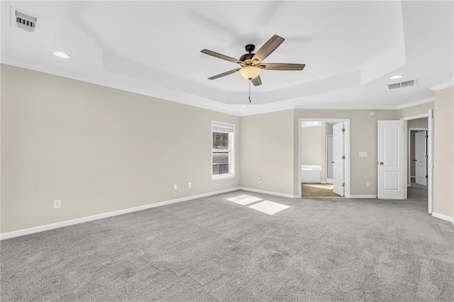 unfurnished bedroom with crown molding, recessed lighting, visible vents, and a raised ceiling