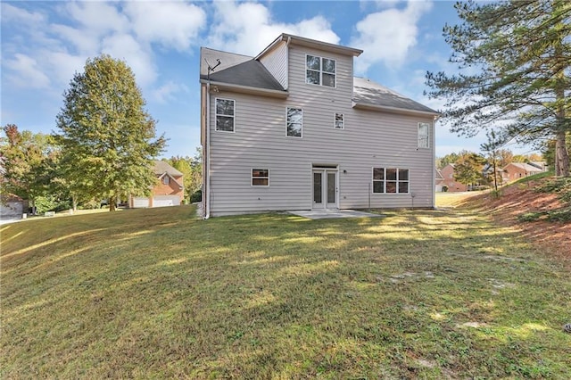 back of house featuring a patio area and a yard
