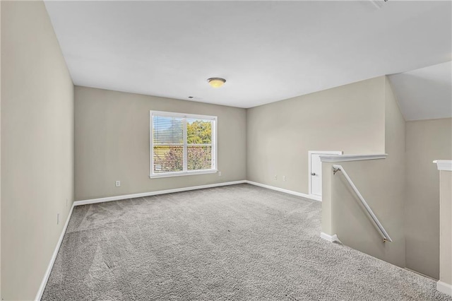 carpeted empty room with baseboards