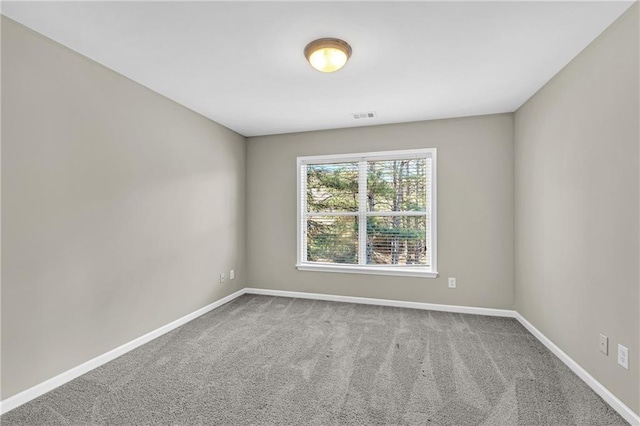 spare room featuring visible vents, baseboards, and carpet floors