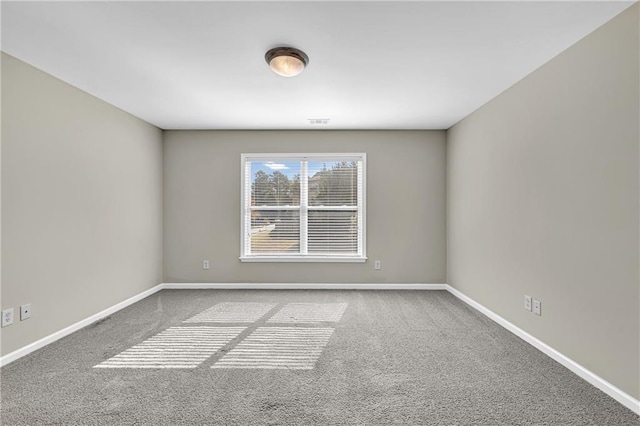 empty room with baseboards, carpet, and visible vents