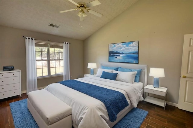 bedroom featuring visible vents, ceiling fan, baseboards, lofted ceiling, and dark wood-style flooring