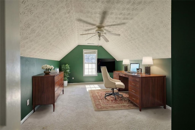 home office with baseboards, a textured ceiling, carpet, and vaulted ceiling