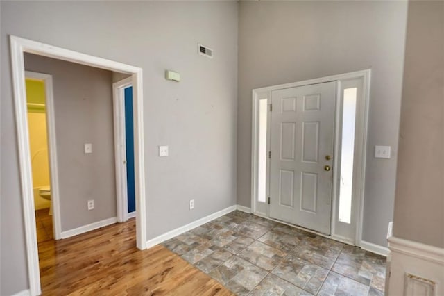 entrance foyer featuring wood finished floors, baseboards, and visible vents