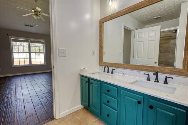 bathroom with a sink, visible vents, and double vanity