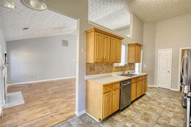 kitchen featuring a sink, baseboards, backsplash, and dishwasher