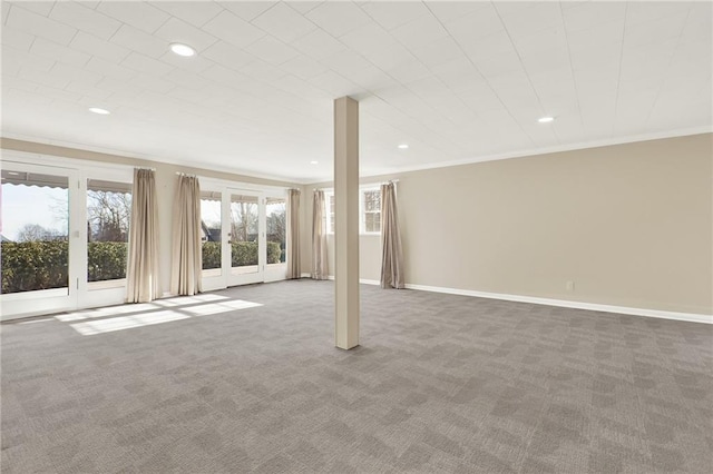 basement featuring carpet flooring and ornamental molding