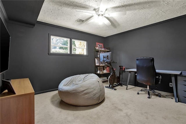 office area featuring ceiling fan, carpet floors, ornamental molding, and a textured ceiling