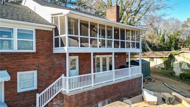 rear view of property with a sunroom