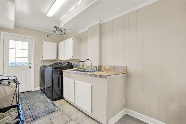 laundry area featuring light tile patterned floors, independent washer and dryer, cabinets, crown molding, and sink