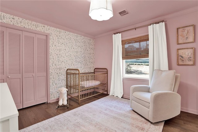 sitting room featuring wood-type flooring and crown molding