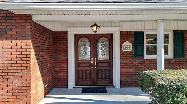 view of exterior entry featuring a porch