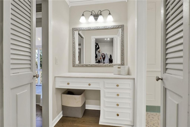 bathroom featuring vanity, wood-type flooring, and ornamental molding