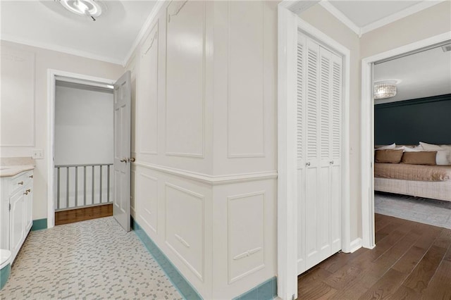 corridor with dark hardwood / wood-style floors and crown molding