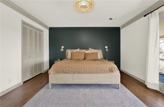 bedroom with light hardwood / wood-style flooring and crown molding