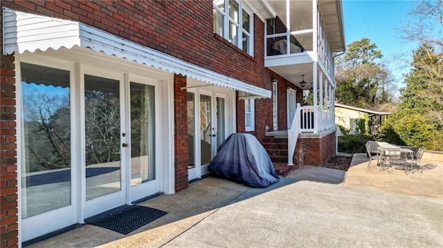 view of side of property with french doors and a patio