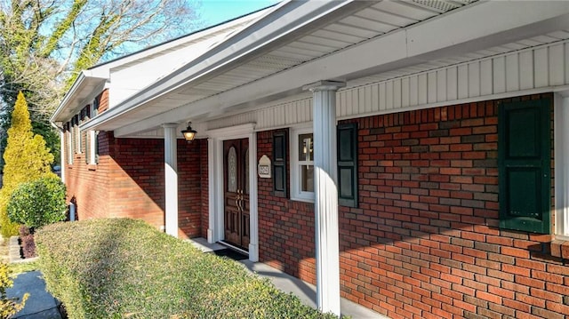 view of side of home featuring covered porch