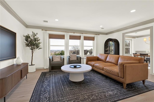 living room featuring light hardwood / wood-style flooring and crown molding