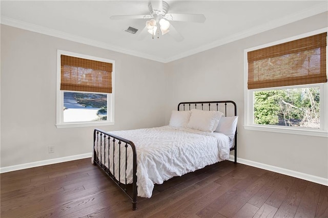 bedroom featuring ceiling fan, dark hardwood / wood-style flooring, and crown molding