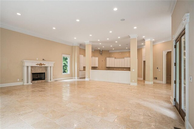 unfurnished living room featuring a premium fireplace and crown molding