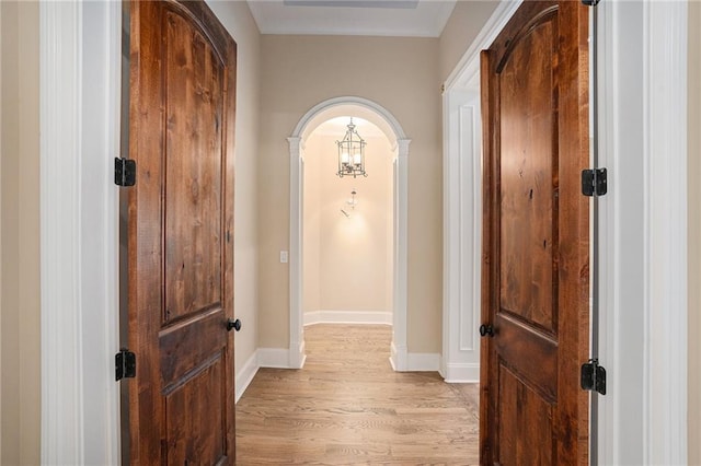hallway with light hardwood / wood-style floors